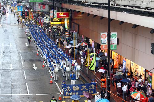 圖1-3：天國樂團引領法輪功學員隊伍，遊行從港島區英皇道、軒尼詩道，途經鬧市銅鑼灣、灣仔、中環，最終到西環中聯辦，歷時三個多小時，沿途吸引港民及中西旅客觀看。